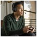 JBL Quantum 100 Wired Over-ear Gaming Headset, Black - Lifestyle attached to controller