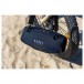 JBL Xtreme 4 Portable Bluetooth Speaker, Black - Lifestyle image at the beach IP67 waterproof and dustproof