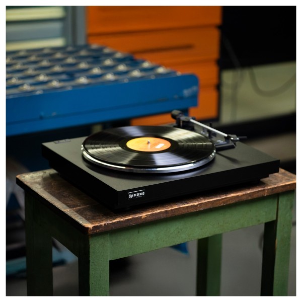Rekkord F110P Fully Automatic Floating Sub-Chassis Turntable with Built-In Phono Stage, Black- lifestyle on green bench 