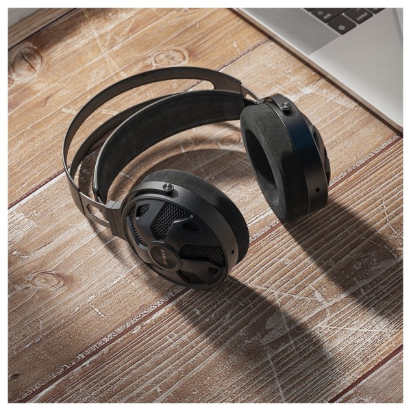 FiiO FT3 32Ω Edition Dynamic High-Res Over-Ear Headphones - wooden surface with macbook in corner. 