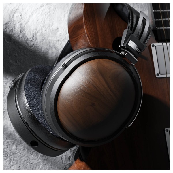 FiiO FT1 32Ω Closed-Back Headphones, Black - Lifestyle image, hanging from walnut guitar