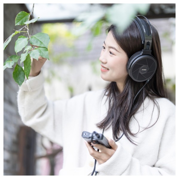 FiiO FT5 Open-Back Planar Magnetic Headphones, Black - Lifestyle Image, modelled outdoors