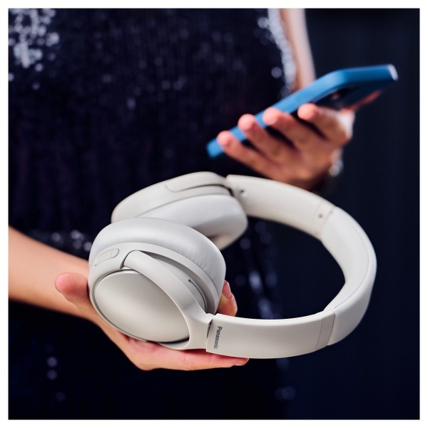 Panasonic RB-M600BE Wireless Stereo Headphones with Hybrid ANC, Beige - Lifestyle image, wirelessly connected to phone
