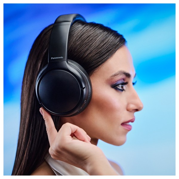 Panasonic RB-M600BE Wireless Stereo Headphones with Hybrid ANC, Black - Lifestyle Image, modelled, side veiw using on-board cont