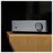 WiiM Vibelink Amplifier, Silver - wooden table 