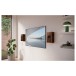 KEF Q4 Meta On-Wall Speaker (Single), Walnut - Lifestyle Image, up-close, with TV