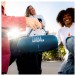 JBL Charge 6 Portable Bluetooth Speaker - Lifestyle Image, Outdoors, held by strap