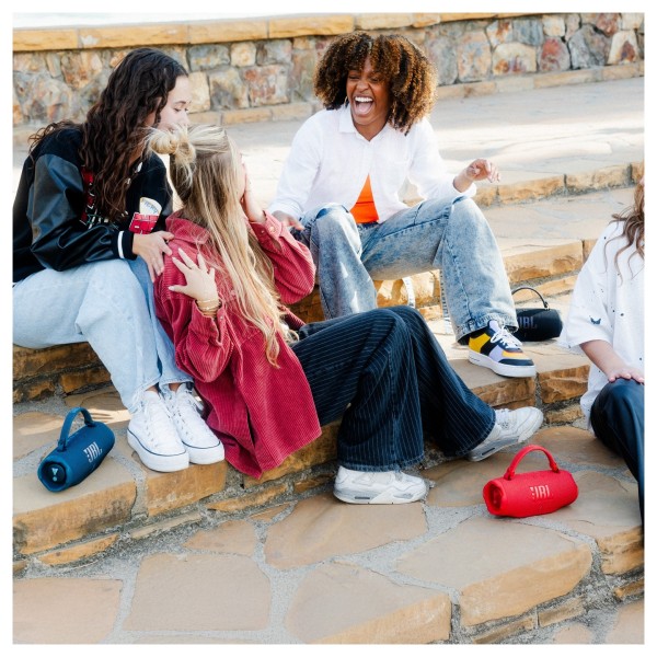 JBL Charge 6 Portable Bluetooth Speaker - Lifestyle Image, Outdoors, sitting on steps, Auracast party