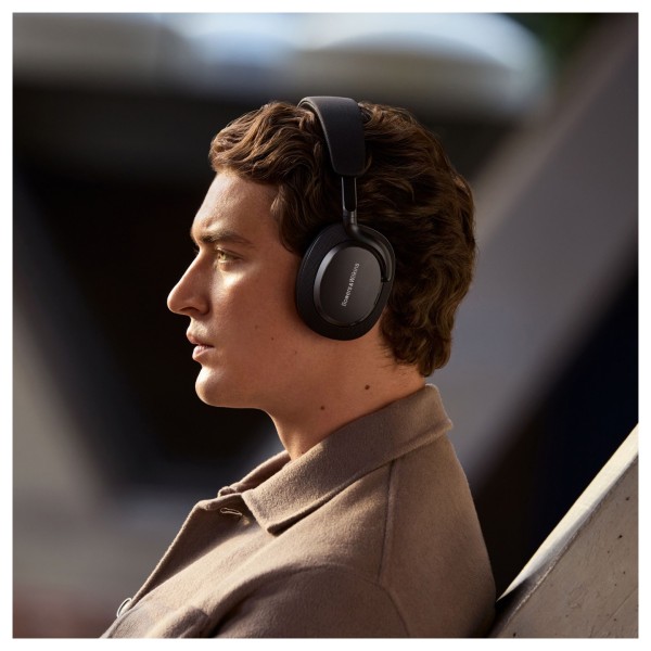 Bowers & Wilkins Px7 S3 Wireless Headphones, Anthracite Black - Lifestyle image, worn by man outdoors, active noise cancellation