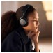 Bowers & Wilkins Px7 S3 Wireless Headphones, Anthracite Black - Lifestyle image, worn by woman, listening to music