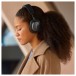Bowers & Wilkins Px7 S3 Wireless Headphones, Anthracite Black - Lifestyle image, worn by woman