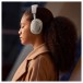 Bowers & Wilkins Px7 S3 Wireless Headphones, Vintage Champagne - Lifestyle image, worn by woman, immersed
