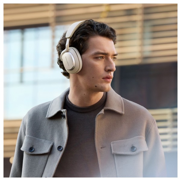 Bowers & Wilkins Px7 S3 Wireless Headphones, Vintage Champagne - Lifestyle image, worn by man outdoors, active noise cancellatio