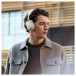 Bowers & Wilkins Px7 S3 Wireless Headphones, Vintage Champagne - Lifestyle image, worn by man outdoors, active noise cancellatio