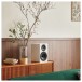 Elipson Prestige Facet II 6B Bookshelf Speakers (Pair), White Matt - Lifestyle Image, side cabinet