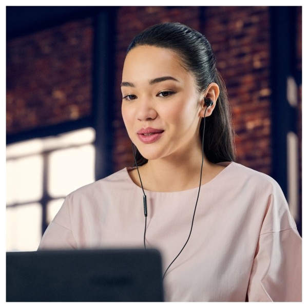 Panasonic RP-TCM225DE USB-C Earphones, Black - Lifestyle Image, modelled, connected to laptop, internet cafe