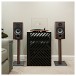 ELAC Debut B6.2 Bookshelf Speaker (Pair), Walnut - Lifestyle, with hi-fi cabinet and stands