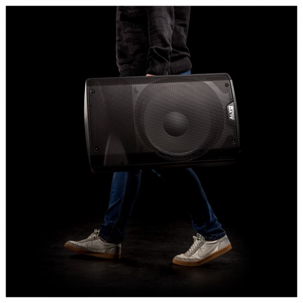 Alto TX312 700 Watt Active Speakers With Stands, Pair - Speaker Being Carried
