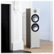 Monitor Audio Bronze 500 Floorstanding Speakers (Pair), Urban Grey stood by a fireplace