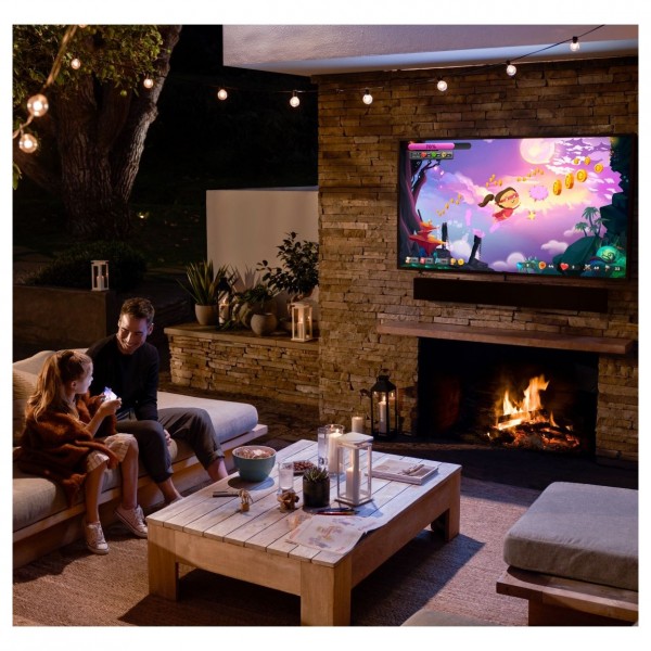 Samsung 65" Terrace QLED 4K HDR Outdoor TV and Free Terrace Soundbar, lifestyle setup on garden patio